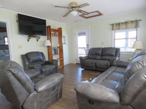 Top floor living room area has large smart tv w/ cable 