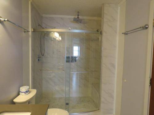 Top floor master bath w/ large shower w/ 3 shower heads and a bench 