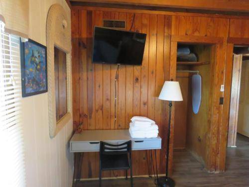 Bunk room has a smart tv and a desk 