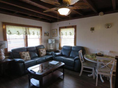 Living room has leather, reclining furniture 