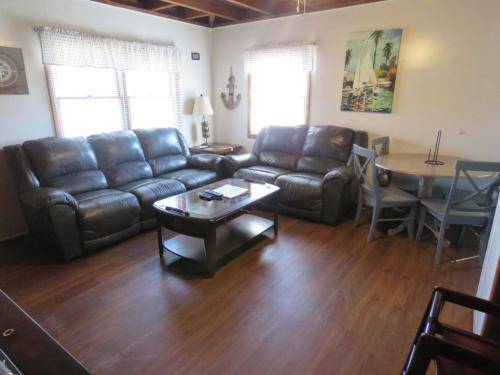 Living room has leather, reclining furniture and a Foosball Coffee table 