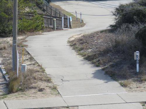 The beach access is right across the street, up this driveway, and through the 2 white poles 